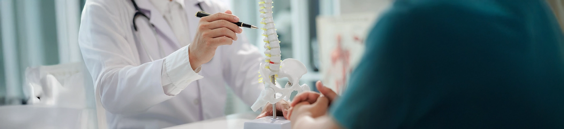 Patient sitting with a doctor during a consultation about chronic back pain.