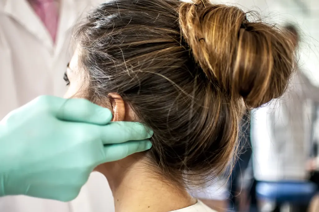 A pain specialist examining a patient with facial pain