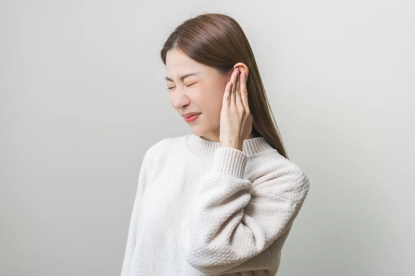 Woman experiencing facial pain