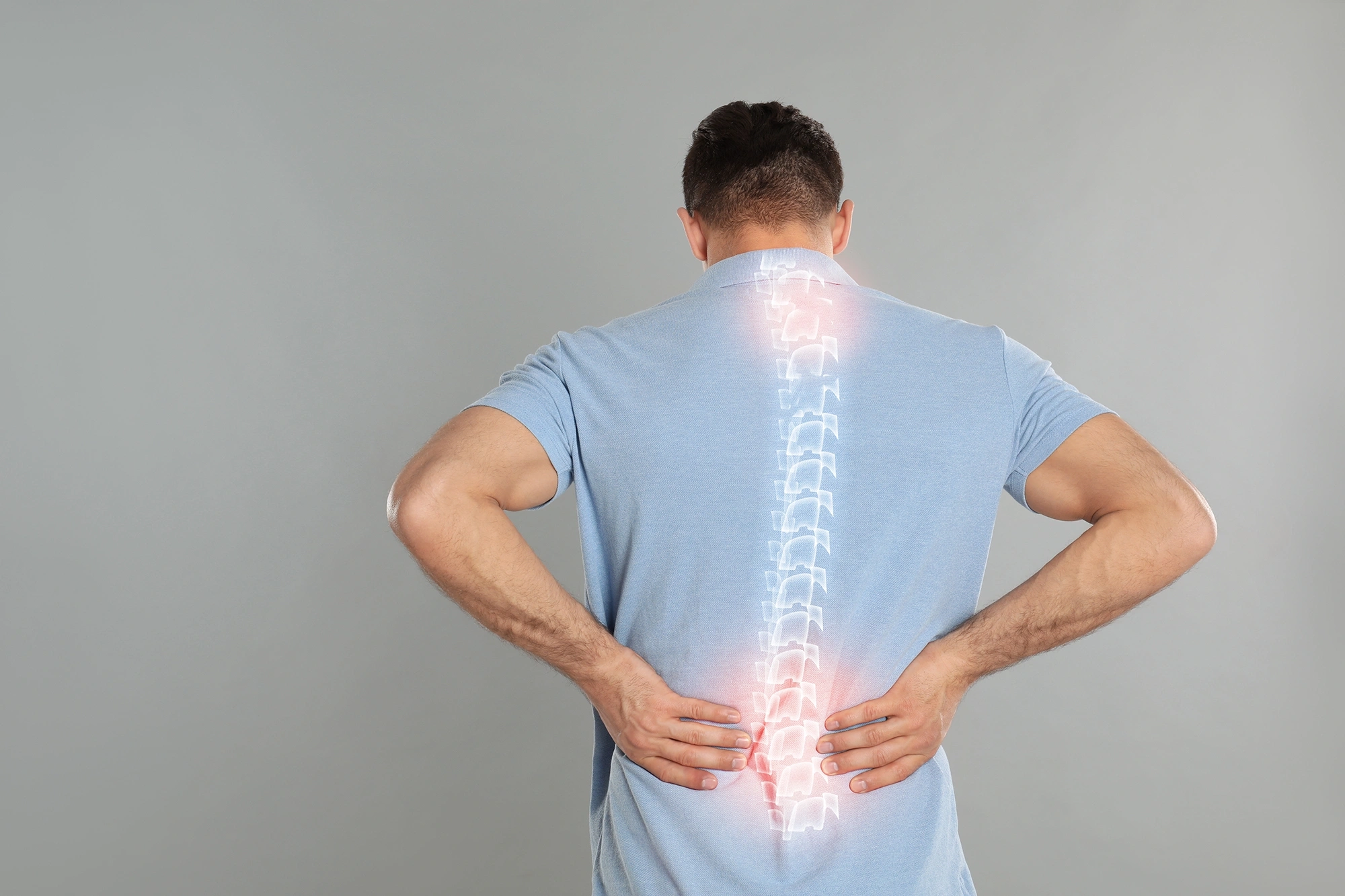 Man suffering from neck and lower back pain