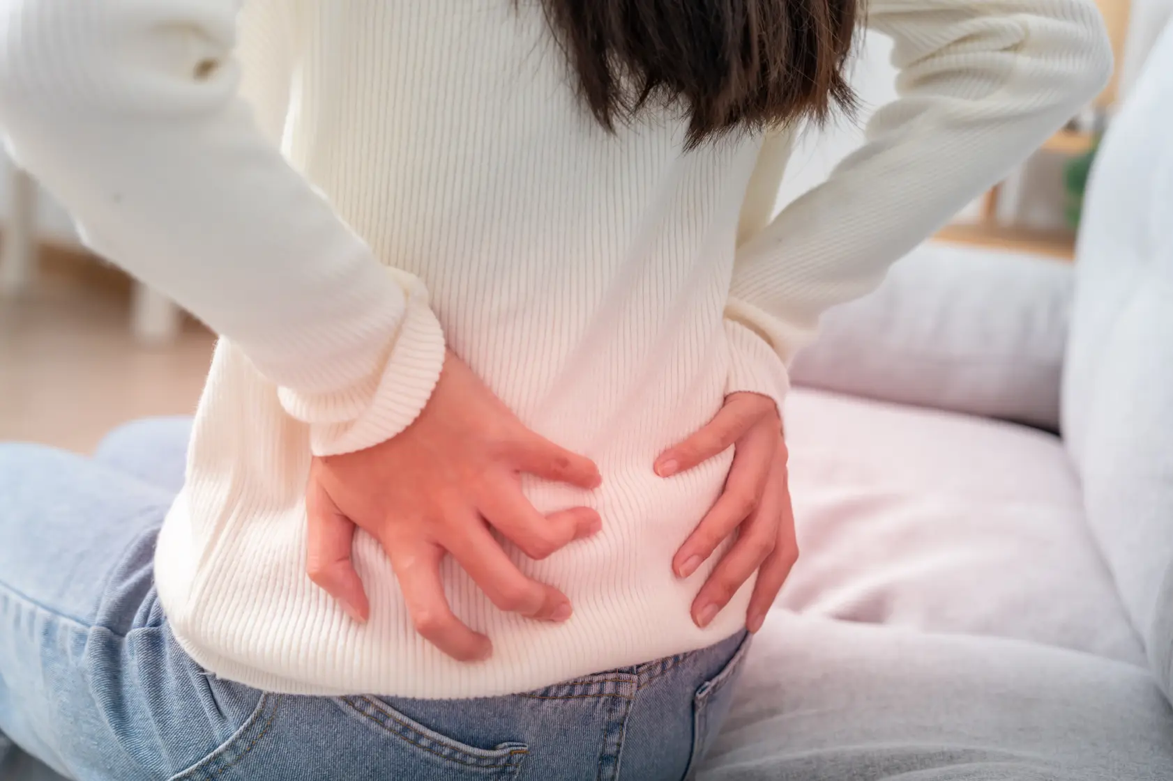 Woman experiencing lower back pain