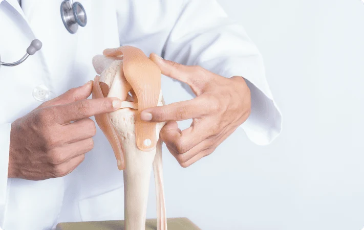 Doctor examining patient with knee pain