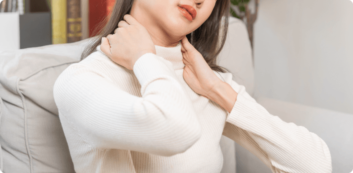 Person experiencing neck pain symptoms