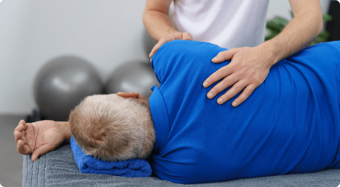 Doctor explaining treatment options to patient with spine model