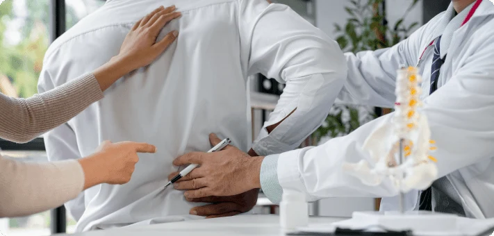 Doctor examining patient with sciatica
