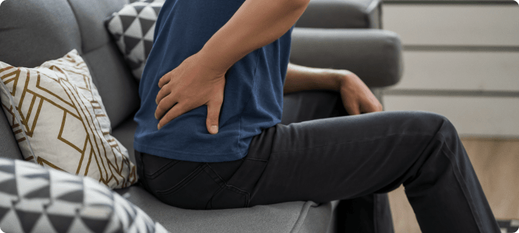 Person experiencing sciatica symptoms