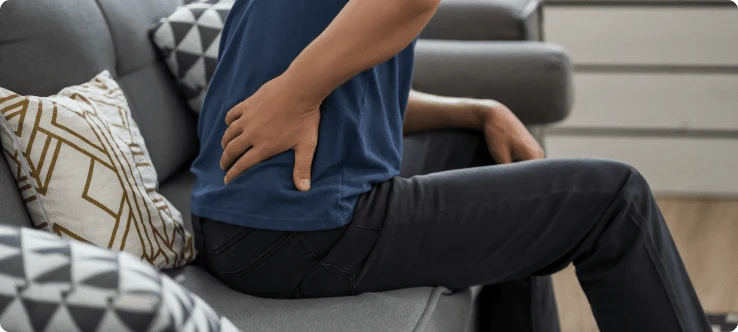 Person experiencing sciatica symptoms
